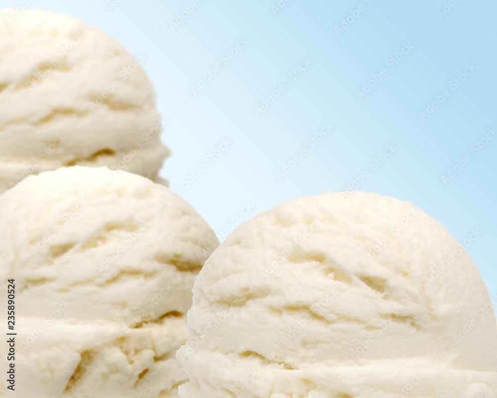 Vanilla ice cream scoops isolated on blue background Vanilla ice cream scoops isolated on blue background