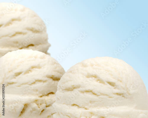 Vanilla ice cream scoops isolated on blue background