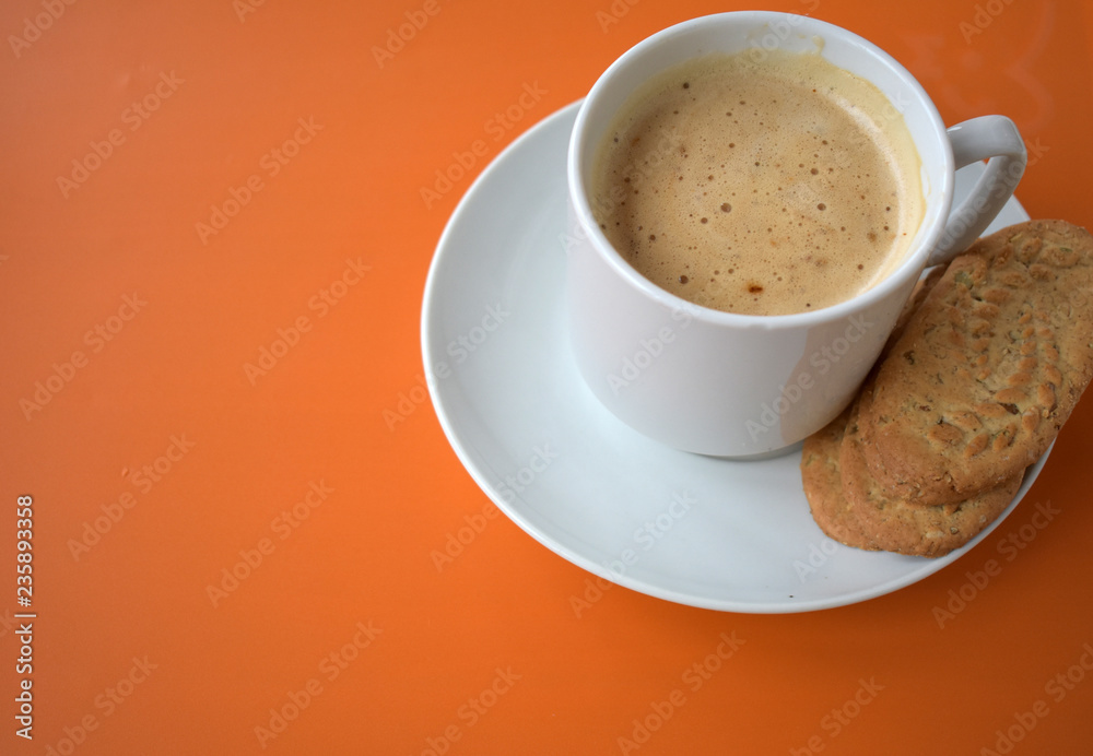 Fototapeta premium Cup of coffee on orange background.