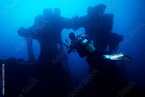 photographer diver taking a picture of a wreck