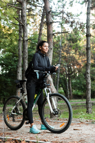 Smiling young woman riding at the park