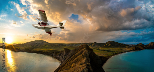 Fotografija ydroplane flying over beauty sea bay