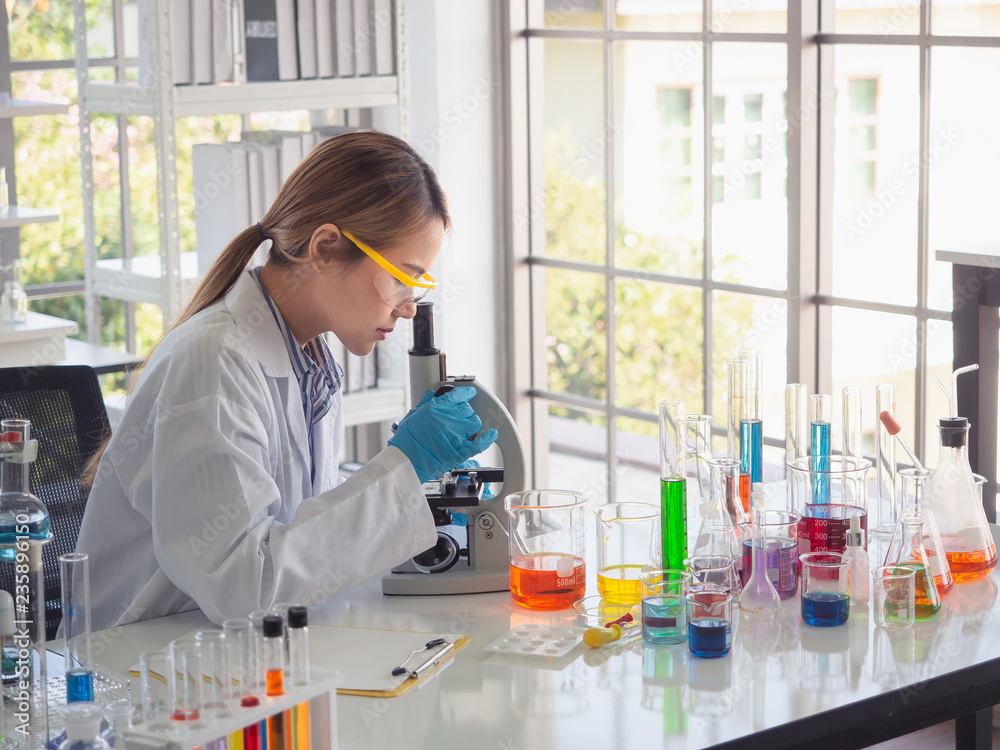 asian scientist working in laboratory with microscope asian scientist working in laboratory with microscope
