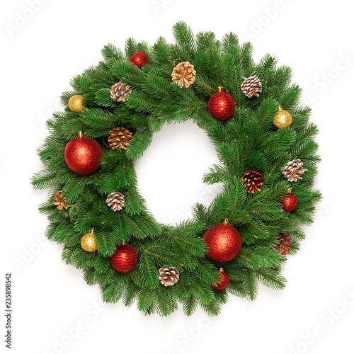 Christmas tree branches in a circle frame isolated on white background with copy space for text. Round wreath fir with Christmas toy balls and fir cones. Flat lay