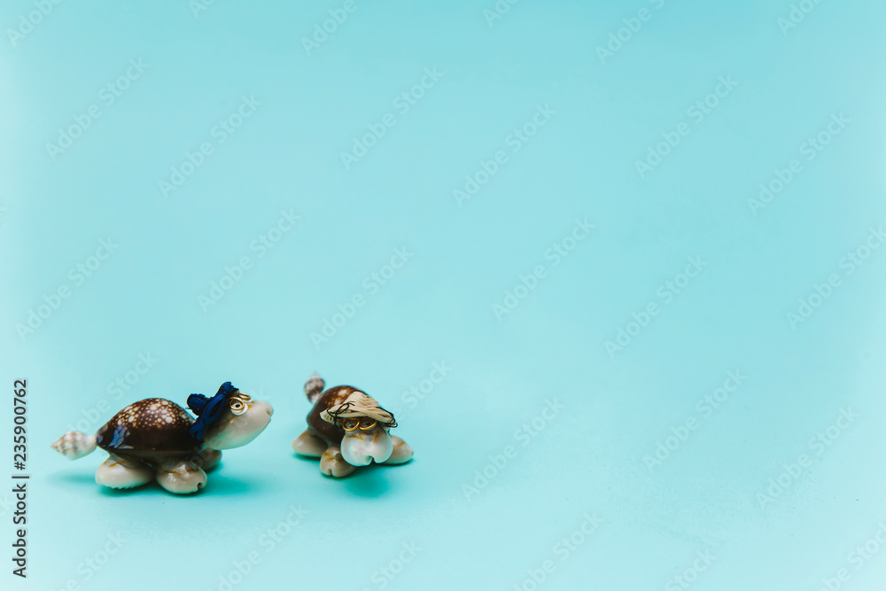 Figures of sea turtles, souvenirs brought from vacation, on a blue background Figures of sea turtles, souvenirs brought from vacation, on a blue background