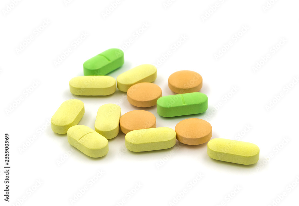 Multicolored tablets and pills on a white background Multicolored tablets and pills on a white background