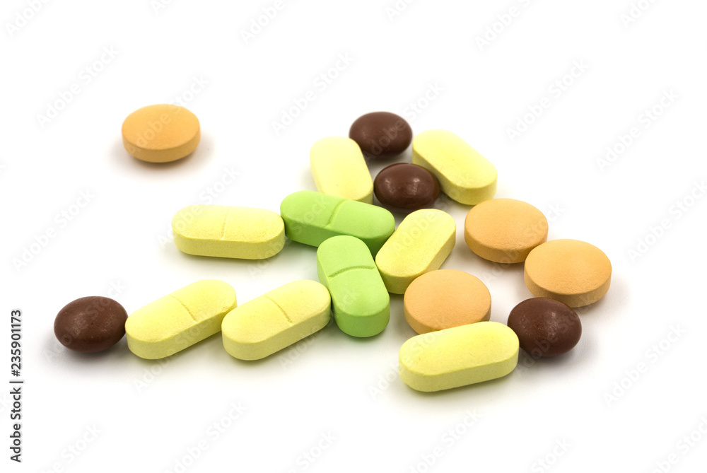 Multicolored tablets and pills on a white background Multicolored tablets and pills on a white background