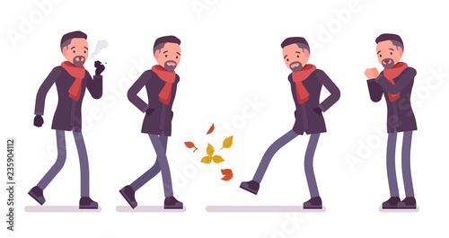Stylish middle aged man in autumn wear smoking, feeling cold