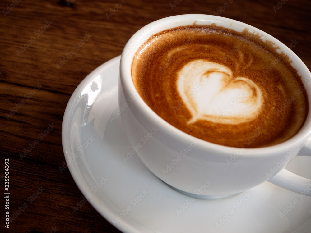 Hot coffee with soft bubble on old wooden boards.