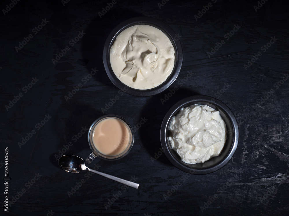 Breakfast of dairy products in dark dishes