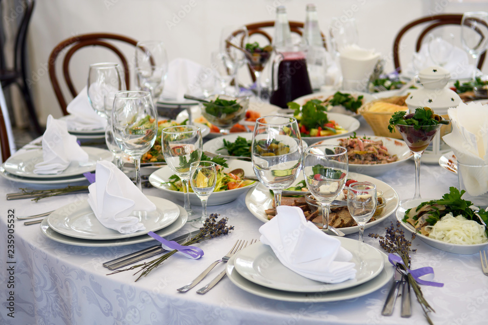 Wedding tables with food for the Banquet. Interior in soft colors for guests at the party.