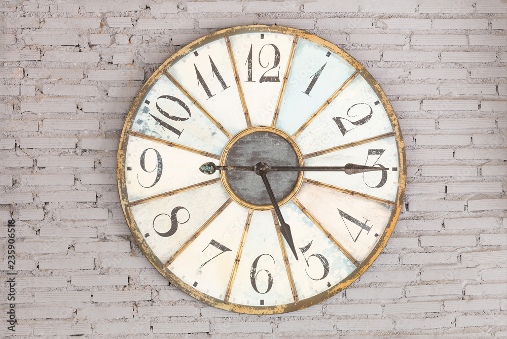Retro clock showing five fifteen on the wall Retro clock showing five fifteen on the wall
