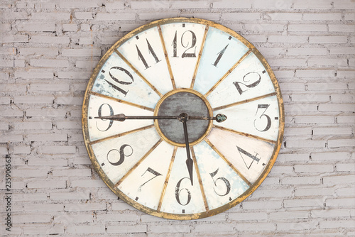 Retro clock showing five forty five on the wall