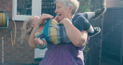 Grandmother throwing toddler around