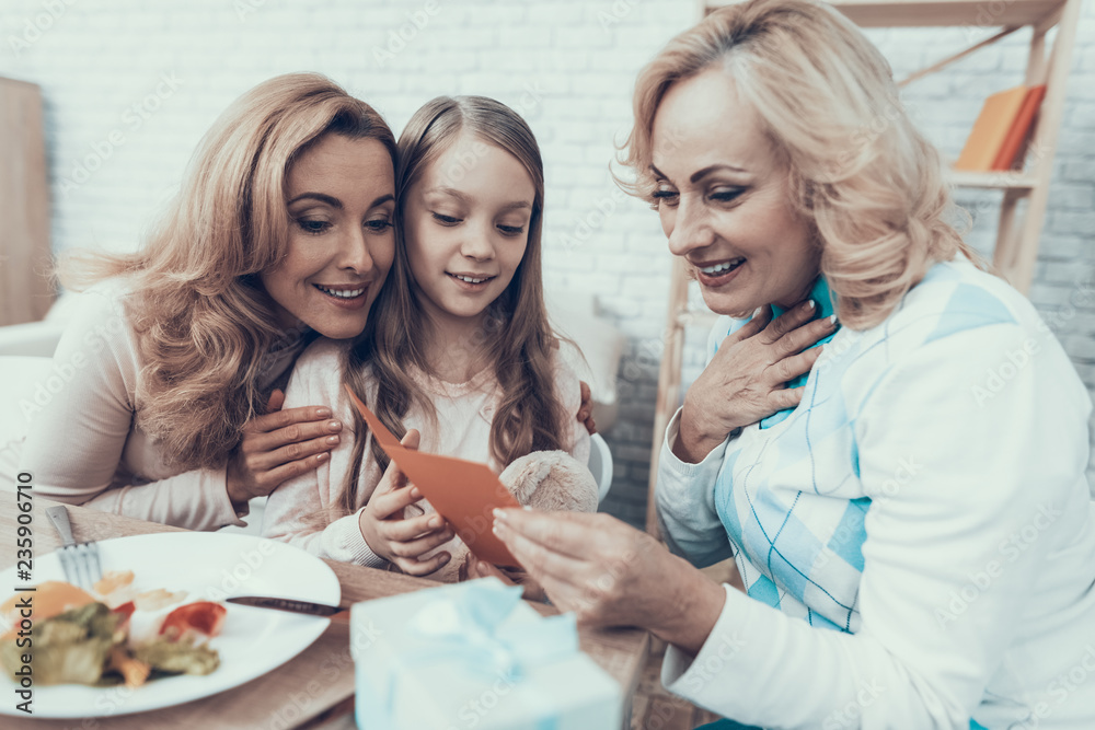 Family Watching into Greeting Card on Celebration. Family Watching into Greeting Card on Celebration.