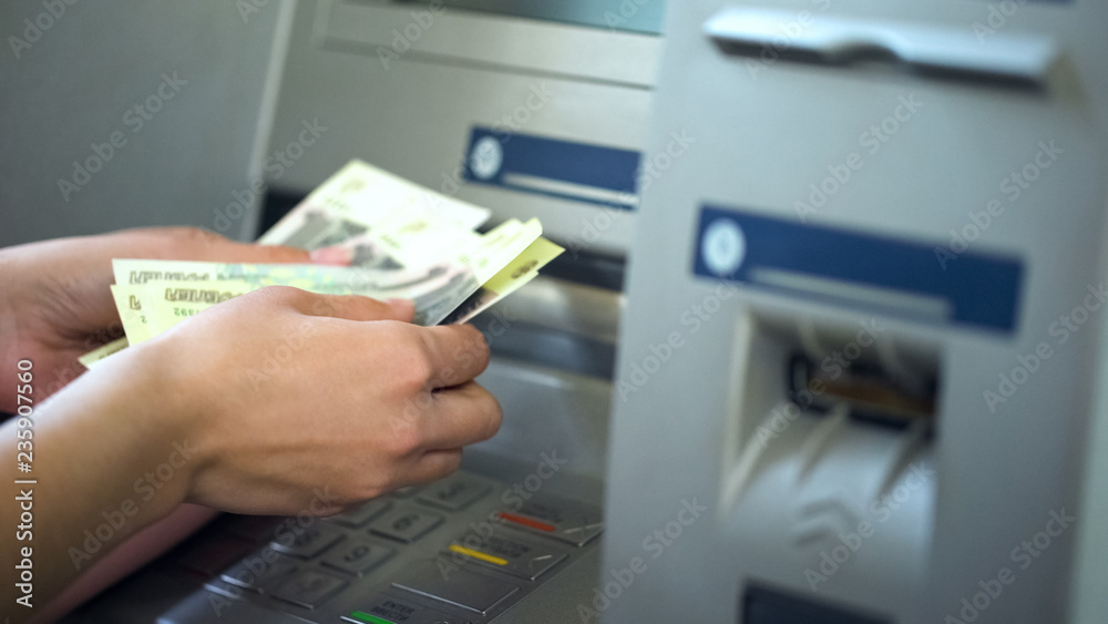 Female counting Russian rubles withdrawn from ATM, 24h service, easy banking Female counting Russian rubles withdrawn from ATM, 24h service, easy banking