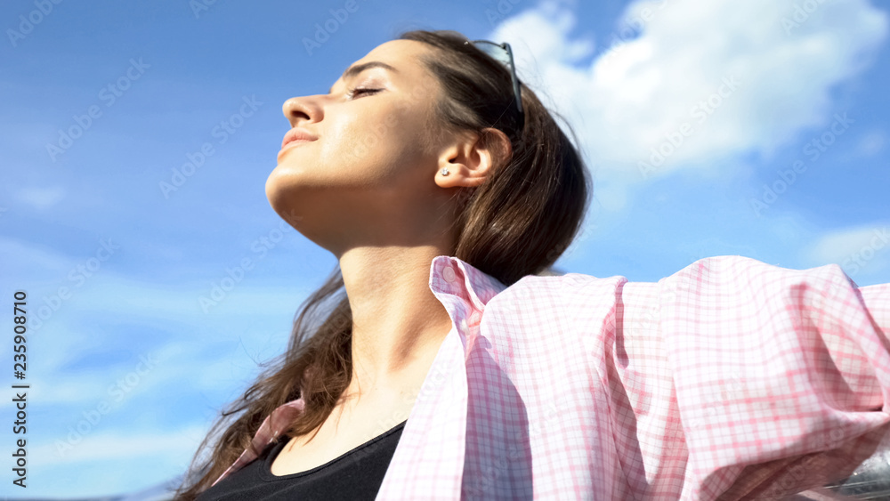 Young beautiful lady enjoying vacations on seaside, freedom inspiration closeup Young beautiful lady enjoying vacations on seaside, freedom inspiration closeup