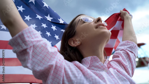 American football fan holding flag and singing USA anthem to support team, cheer
