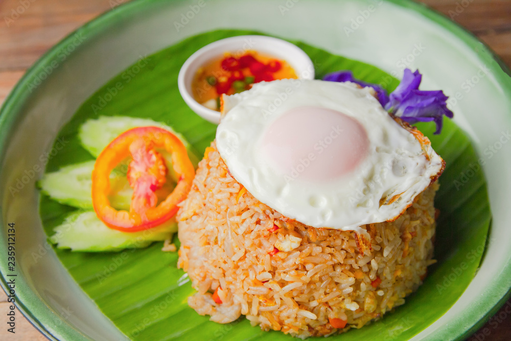 Fried rice with Fried egg pork, Cucumber and tomato on plate. top view
