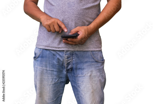 Closeup of man in blue jeans using smart phone on white background.
