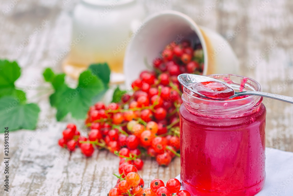 Red currants and jar of jam in garden. Natural light. Red currants and jar of jam in garden. Natural light.