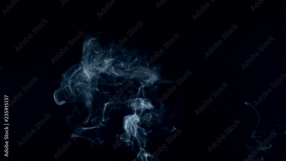 Thin stream of smoke is flowing in the dark Thin stream of smoke is flowing in the dark