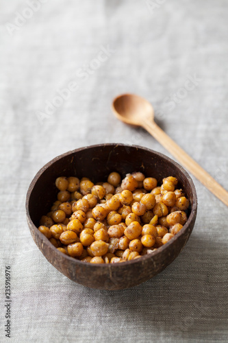 Spicy roasted chickpeas in coconut bowl