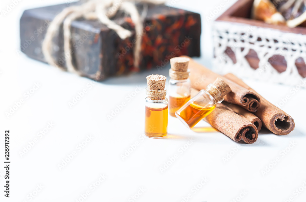 Essential oil cinnamon in glass bottle. Spa concept Essential oil cinnamon in glass bottle. Spa concept