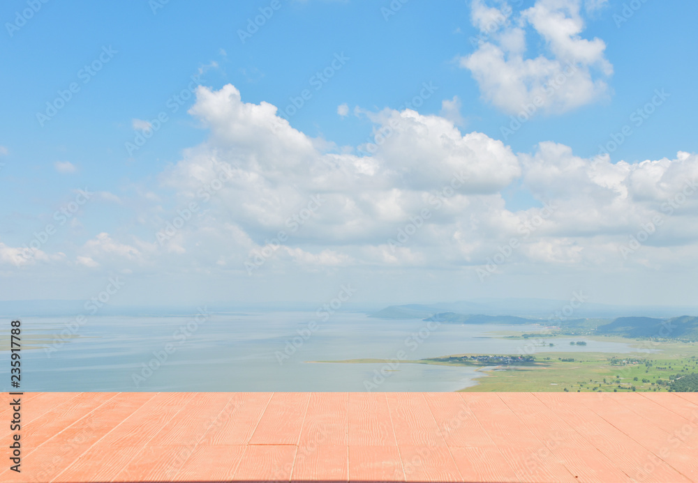 Fototapeta premium There is wooden balcony front the lake with cloud in blue sky.