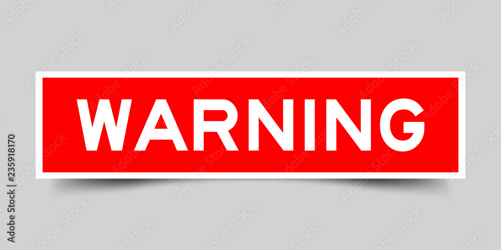 Square red sticker label in word warning on gray background Square red sticker label in word warning on gray background