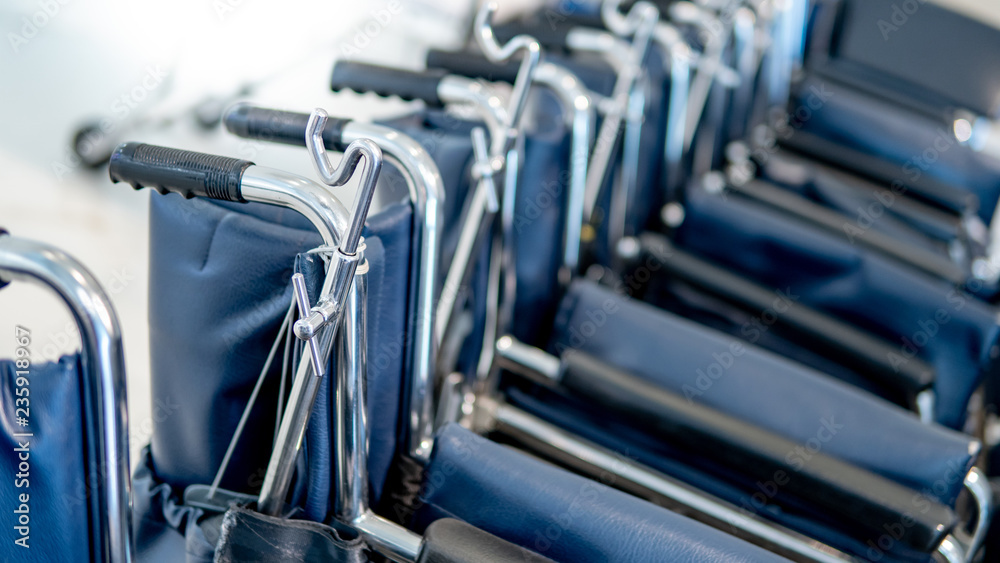 Group of blue folding wheelchair in hospital or medical clinic. Healthcare and medical service concept Group of blue folding wheelchair in hospital or medical clinic. Healthcare and medical service concept