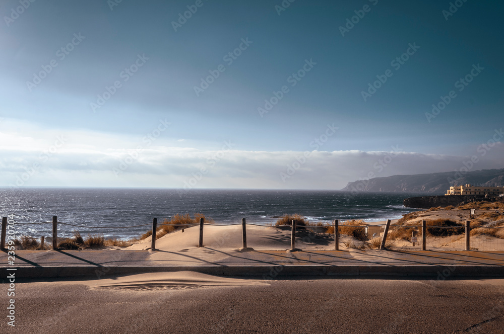 Ocean view from the road coveden in sand dunes on Portugal, Guincho, Sintra