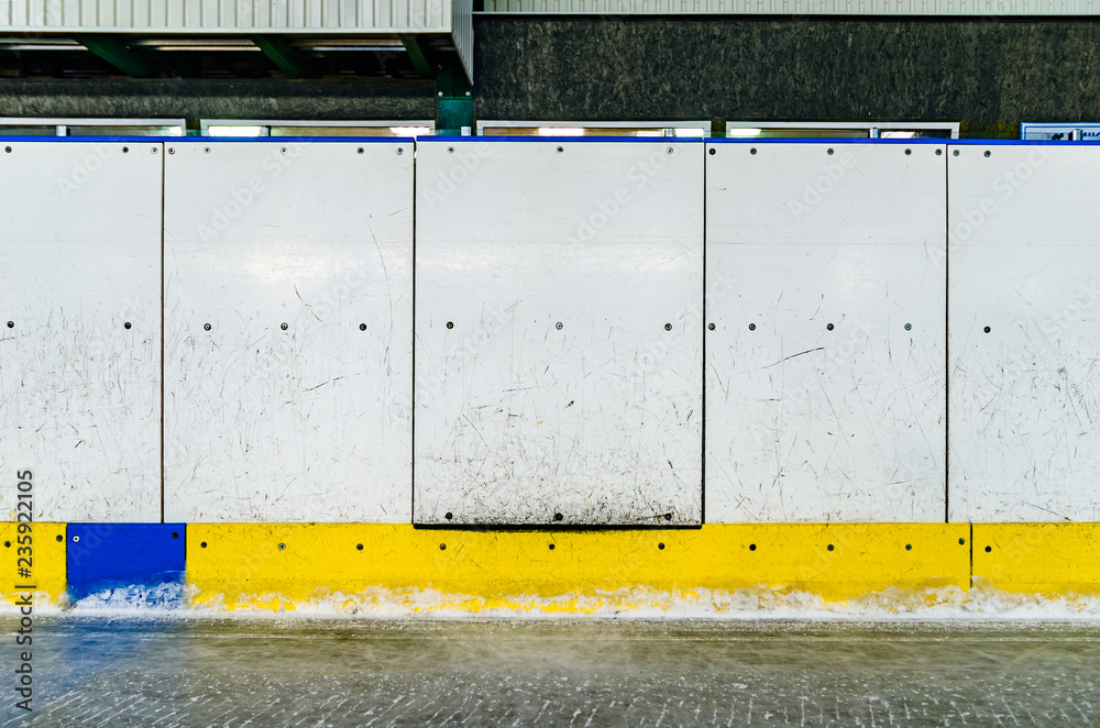 Fototapeta premium Hockey rink side boards with door and scratched and damaged surface