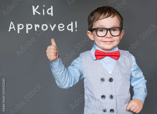 Cute little boy giving thumbs up and Kid approved