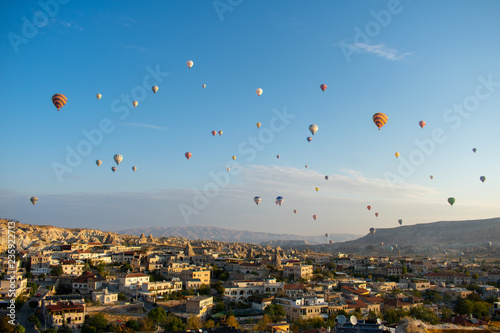 Aerial view on Sunrise over Cappadocia. Balloons flying against blue sky. Goreme most popular place in Turkey 