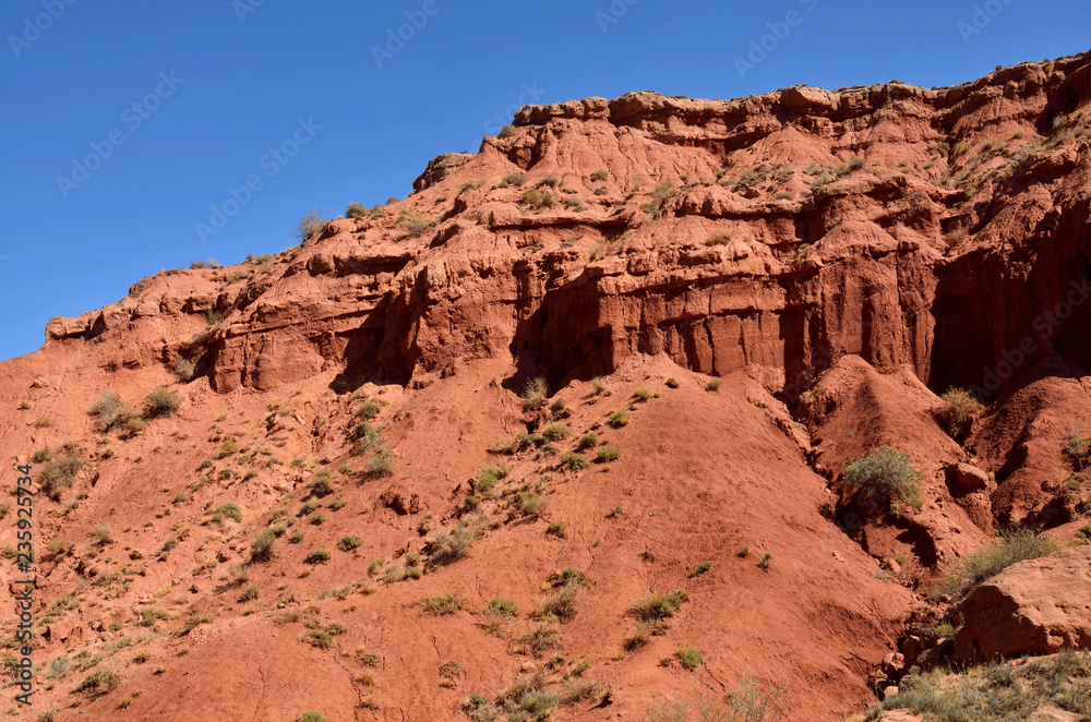 Red sandstone rocks of Konorchek canyon,Kirgyzstan,Central Asia, famous trekking place Red sandstone rocks of Konorchek canyon,Kirgyzstan,Central Asia, famous trekking place