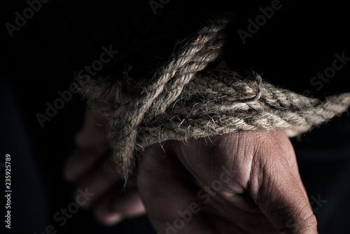 Tableau sur toile man with his hands tied behind his back
