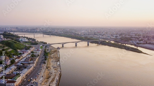 Aerial view of Kanavinsky Bridge across the Oka river from the river side during sunset. Nizhny Novgorod, Russia photo