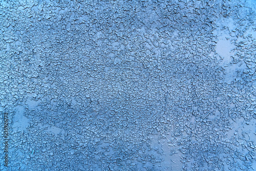 Purple cracked paint on grey concrete surface