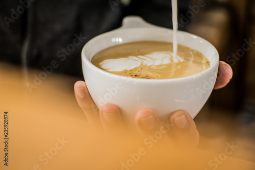 Barista finishing latte arte