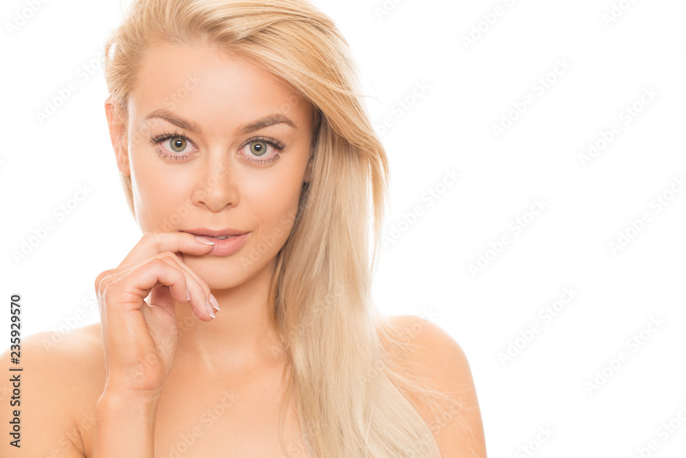 Close up studio portrait of a stunning beautiful young blonde woman posing seductively with her finger to her lips isolated cosmetology treatment spa facial care flawless perfection unblemished Close up studio portrait of a stunning beautiful young blonde woman posing seductively with her finger to her lips isolated cosmetology treatment spa facial care flawless perfection unblemished