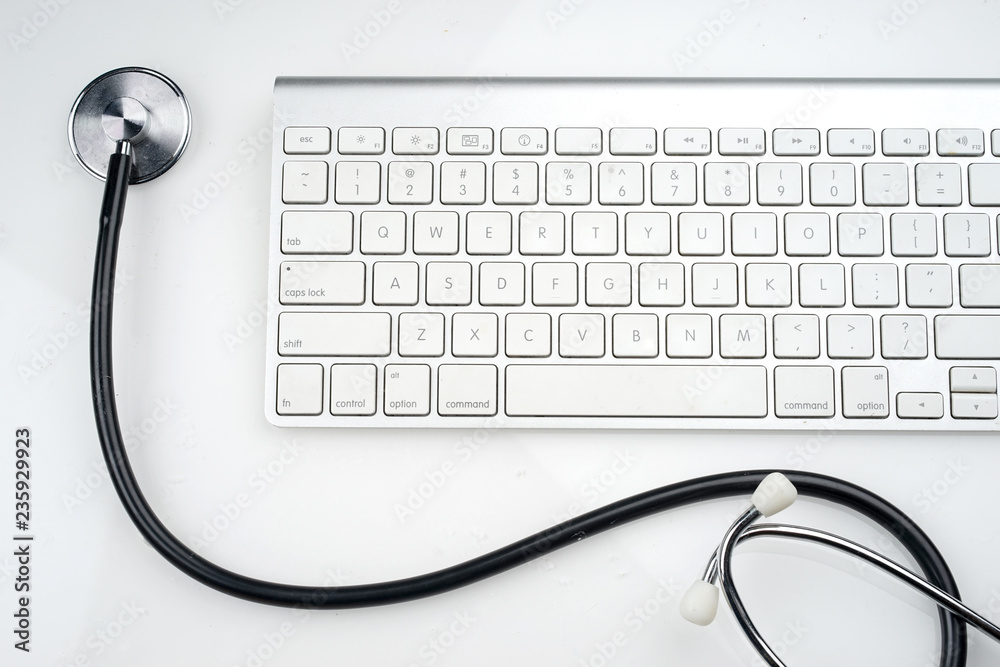Adoption of technology in healthcare industry concept. Stethoscope and keyboard on white background. Flat lay or top view. Adoption of technology in healthcare industry concept. Stethoscope and keyboard on white background. Flat lay or top view.