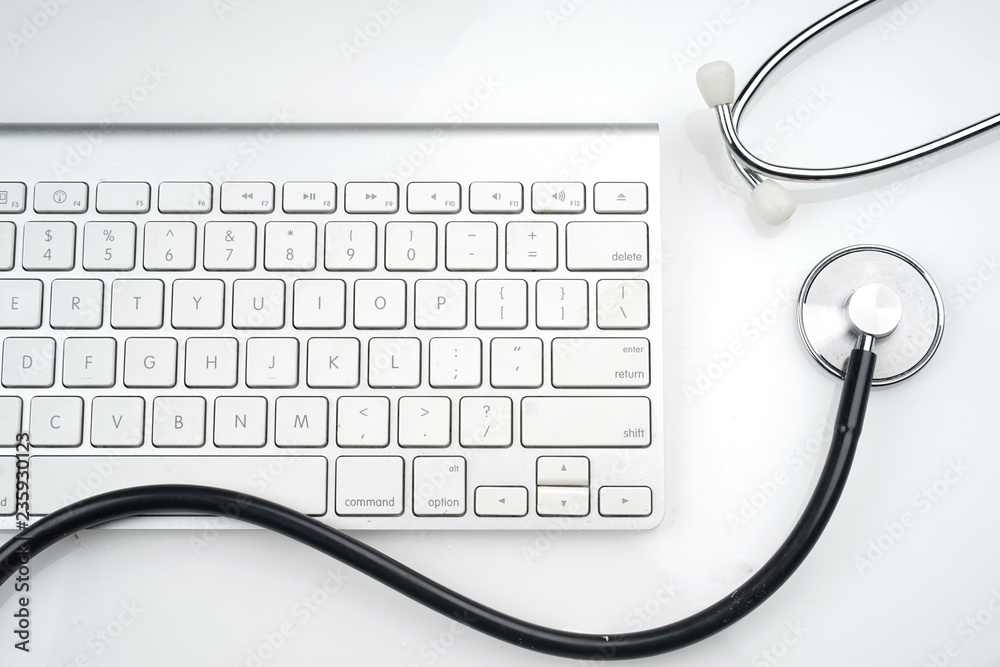 Adoption of technology in healthcare industry concept. Stethoscope and keyboard on white background. Flat lay or top view. Adoption of technology in healthcare industry concept. Stethoscope and keyboard on white background. Flat lay or top view.