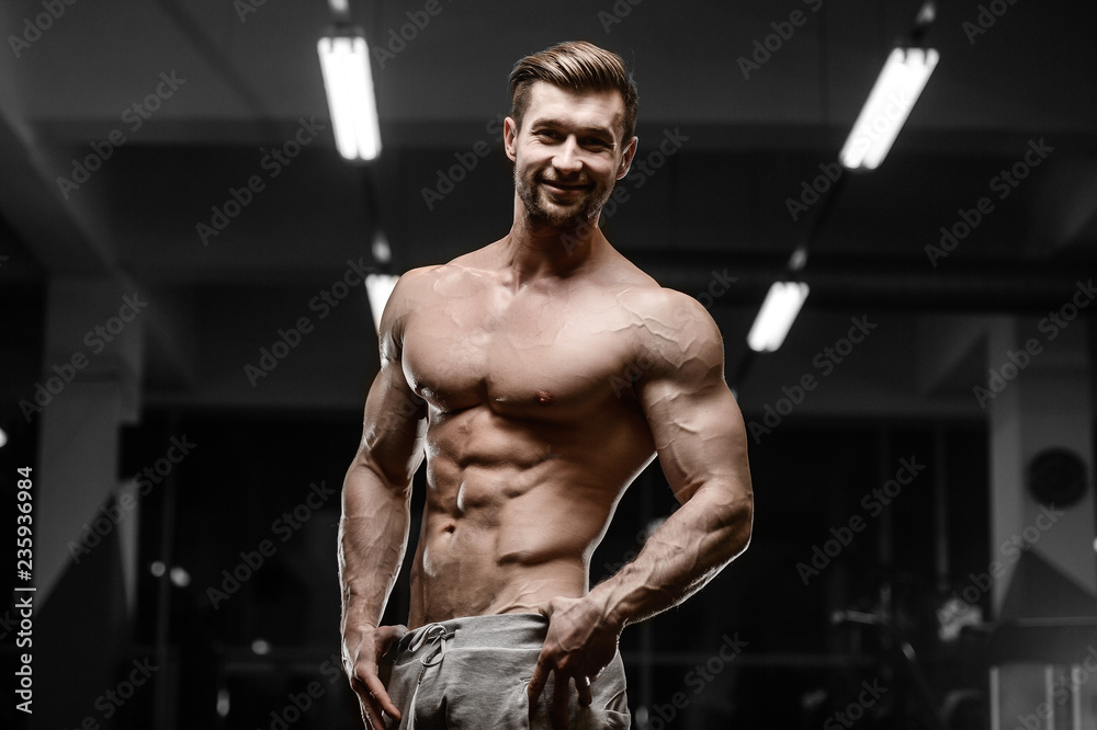 sexy strong bodybuilder athletic men pumping up muscles with dumbbells sexy strong bodybuilder athletic men pumping up muscles with dumbbells