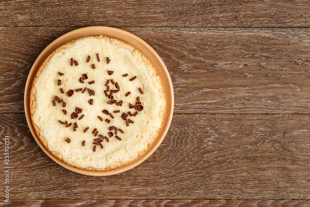 Homemade cheesecake sprinkled with chocolate chips on a wooden background. Top view and copy space Homemade cheesecake sprinkled with chocolate chips on a wooden background. Top view and copy space