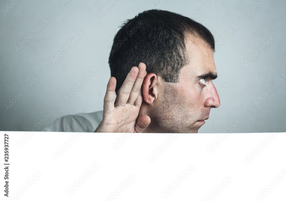 Man hold hand near ear. Trying to hear a gossip. Space for your text Man hold hand near ear. Trying to hear a gossip. Space for your text