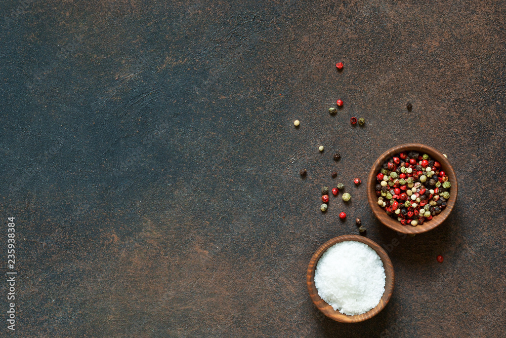 A variety of spices on a concrete background. Salt. Pepper. Top view