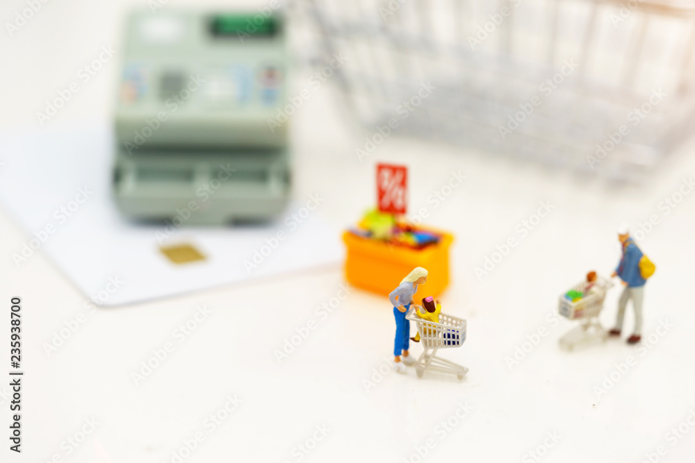 Miniatrue people: Shoppers buy goods on sale with discount tray. Tourism, shopping or business concept. Miniatrue people: Shoppers buy goods on sale with discount tray. Tourism, shopping or business concept.