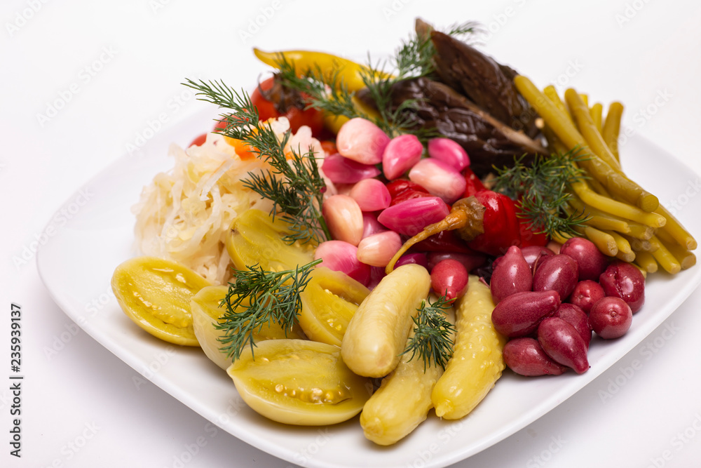 Pickles in assortment on a plate. Restaurant dish.
Pickles in assortment on a plate. Restaurant dish.
