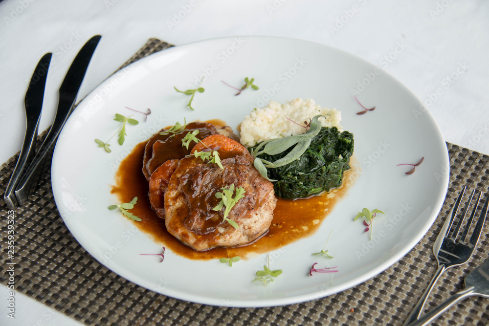 Pork steak with sauce on white plate Pork steak with sauce on white plate